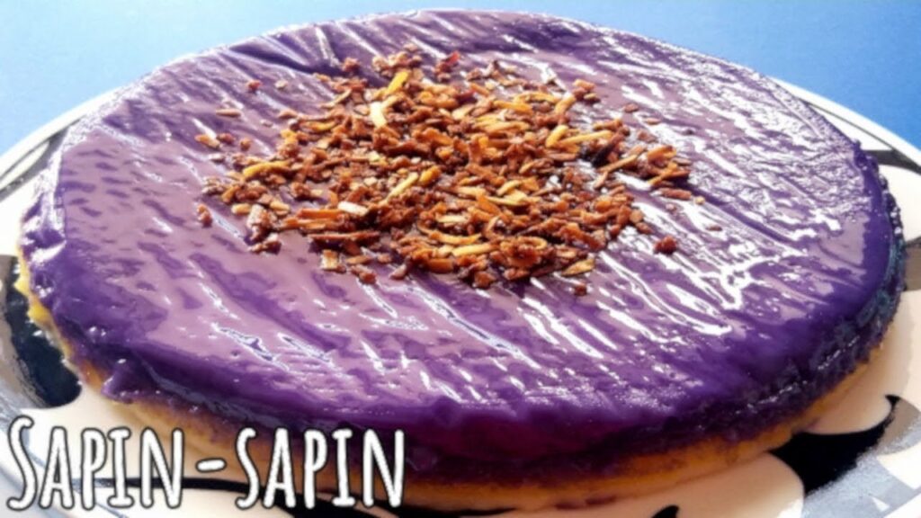 Easy Sapin-Sapin Recipe – 7 Simple Steps to Make This Irresistible Filipino Dessert Easy Sapin-Sapin recipe image featuring a colorful Filipino layered rice cake topped with toasted coconut flakes. A vibrant ube layer sits on top, showcasing the traditional look of this classic kakanin dessert.