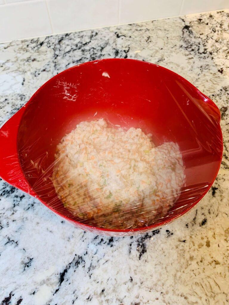 8 Easy Steps to Make the Best Tilapia Fish Ball Recipe at Home Tilapia fish ball mixture covered with cling wrap and chilled in the refrigerator to help firm the texture for shaping.