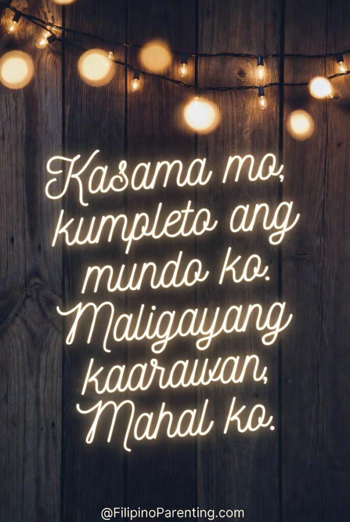 Maligayang Kaarawan Love: 20 Sweet Birthday Messages, Prayers, and Quotes Romantic “Maligayang Kaarawan, Mahal Ko” birthday greeting featuring glowing script typography styled like neon lights against a rustic wooden background with warm string lights. Includes a heartfelt Filipino love message expressing how life feels complete together. Perfect for sending sweet Tagalog birthday wishes to your partner, husband, wife, boyfriend, or girlfriend—ideal for social media posts, digital greeting cards, and romantic birthday celebrations.
