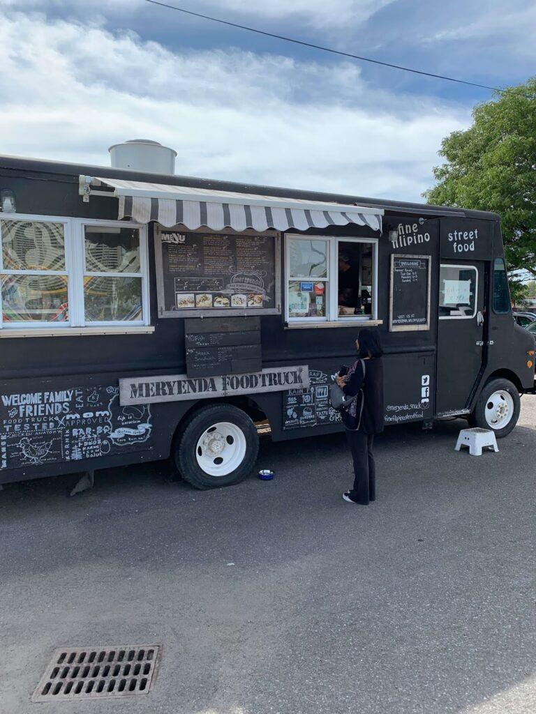 Filipino Food Truck Ottawa: 3 Incredible Must-Try Street Foods from Meryenda A woman ordering at the Meryenda Filipino food truck Ottawa during a family visit.