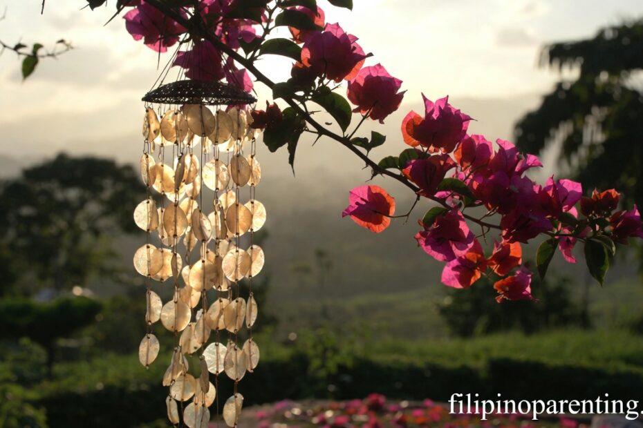 Capiz shell chime in a sunlit garden representing Beautiful Tagalog Expressions Joy Ligaya Happy Heart.