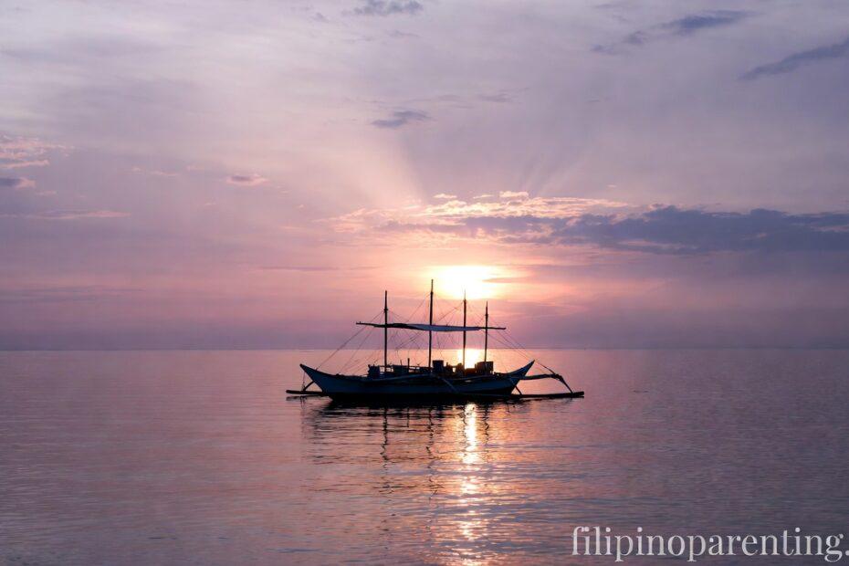 A Bangka on a calm sea at dawn representing Deep Hugot Tagalog Finding Strength Divine Grace.