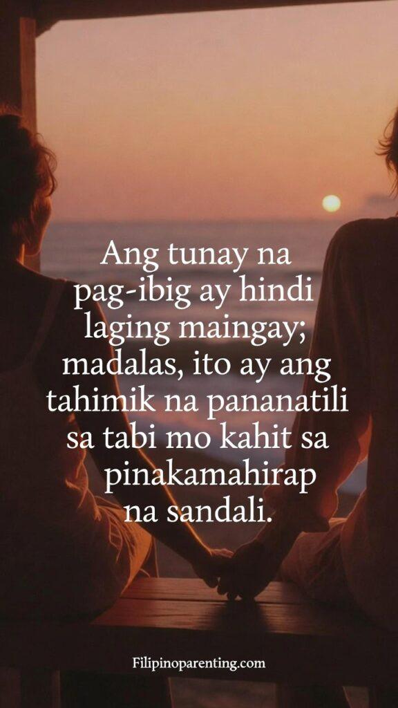 Deep Tagalog Love Quotes for a Gentle Heart: 5 Enchanting Expressions Vertical image showing a couple sitting quietly side-by-side during a sunset, featuring the Tagalog quote about quiet love.