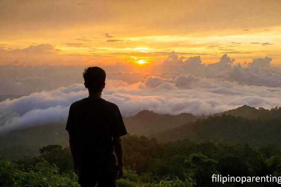 A person finding inspirational Tagalog quotes for inner strength on a mountain peak in the Philippines.
