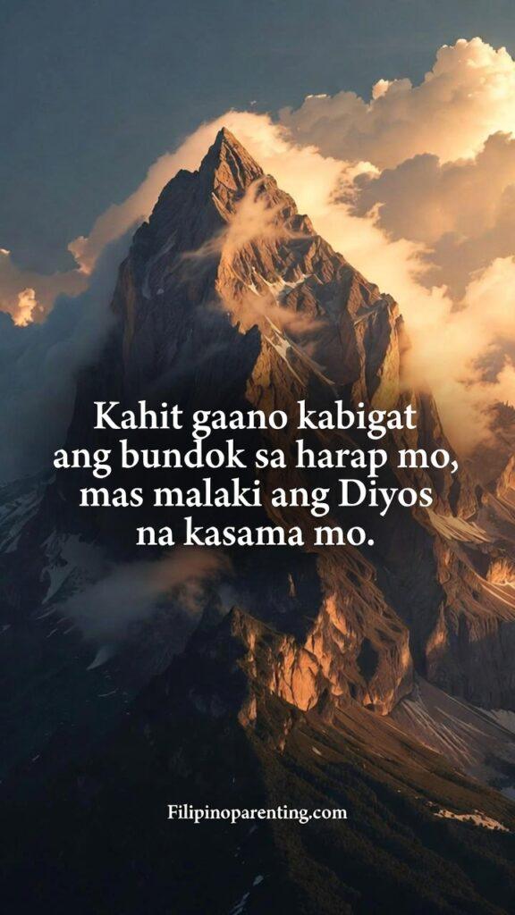 Inspirational Tagalog Quotes for Inner Strength: 5 Unstoppable Lines of Faith A vertical shot of a massive, mist-covered mountain peak with sunlight breaking through the clouds.