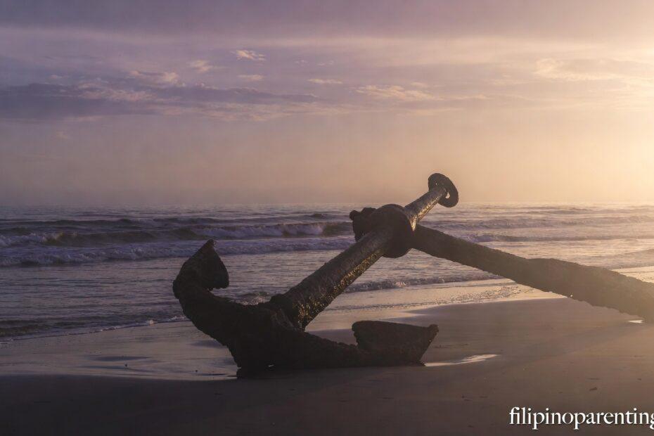 An anchor on a beach at sunrise representing Tagalog Christian Wisdom Navigating Uncertainty.