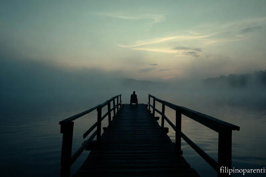 A person sitting on a pier at dusk representing Tagalog Quotes When Life Feels Heavy Tired Heart.