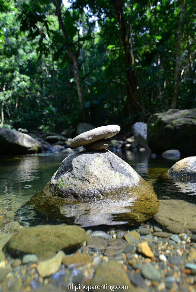 Tagalog Sayings Finding Calm Stillness Clarity: 5 Infinite Truths Balanced stones in a clear stream representing Tagalog Sayings Finding Calm Stillness Clarity.