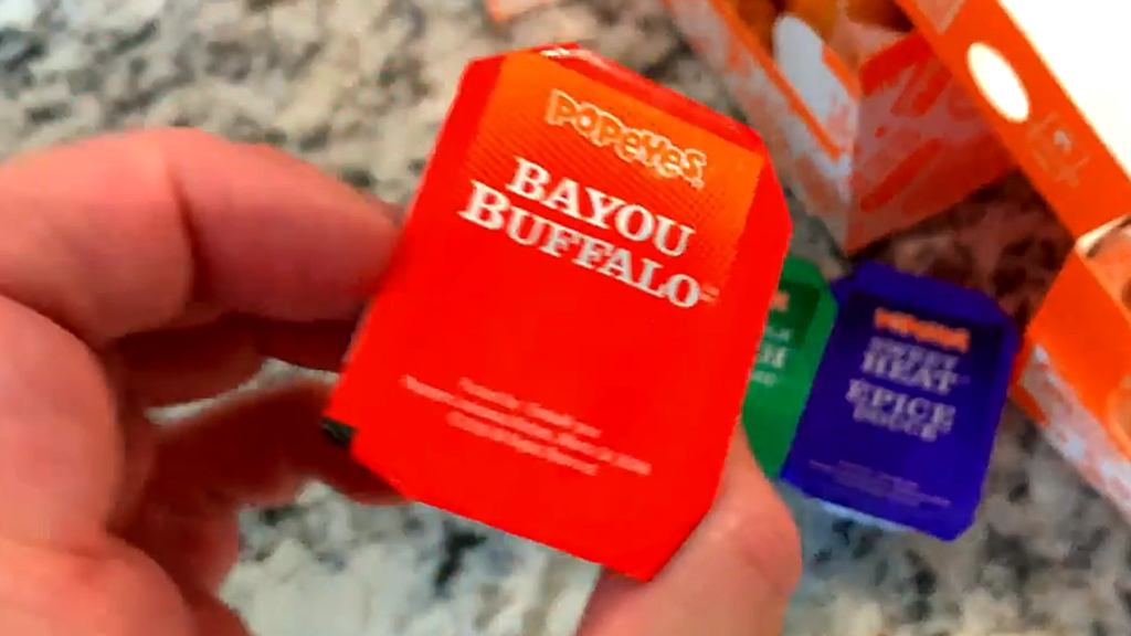 Popeyes Chicken Tenders Pembroke Ontario: 5 Reasons We Often Enjoy This Popular Ontario Fast Food in the GTA Close up of Popeyes Bayou Buffalo dipping sauce with chicken tenders in Pembroke, Ontario.