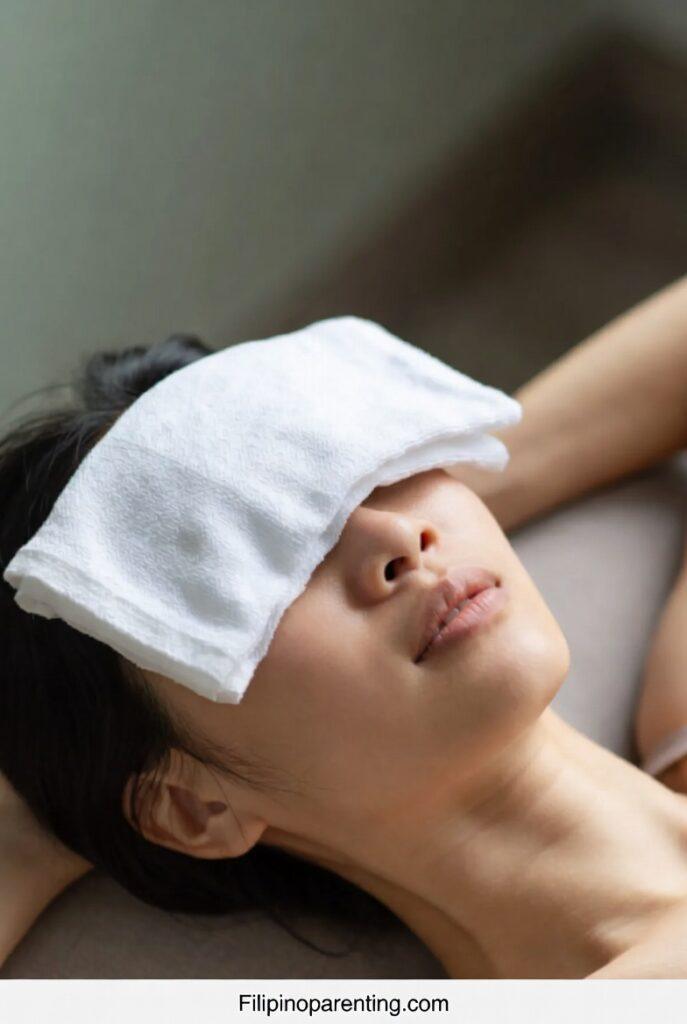 7 Amazing Facts About the Forehead in Tagalog (Noo) for Success A person resting a cool damp cloth on their forehead in Tagalog to relieve pain