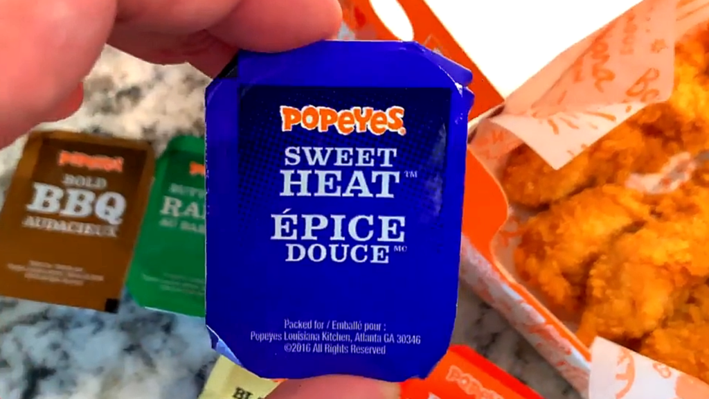 Popeyes Chicken Tenders Pembroke Ontario: 5 Reasons We Often Enjoy This Popular Ontario Fast Food in the GTA Close up of Popeyes Sweet Heat (Épice Douce) dipping sauce with chicken tenders in Pembroke, Ontario.